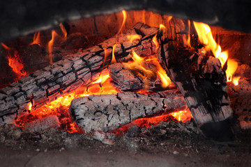 close-up red and yellow flames in the fire of logs