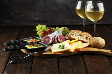 Delicious traditional Swiss melted raclette cheese on diced boiled or baked potato.