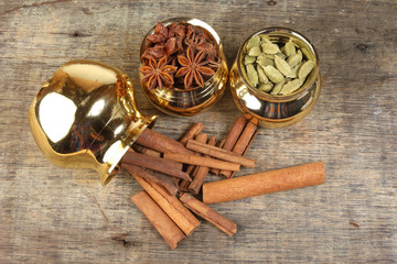 mix spice in golden metal pot on rustic wood