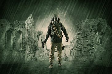 Hazard, menace man in a ruined crumbly building with arms on his hand
