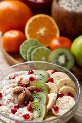 Breakfast still life with oatmeal porridge and fruits, top view, selective focus, shallow depth of field.