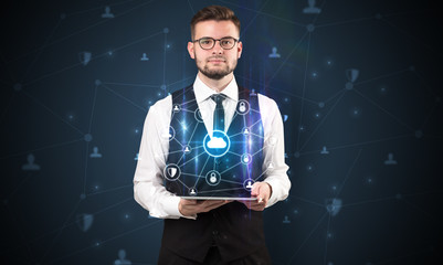 Secured cloud hologram on tablet  holded by spectacled young businessman in suit
