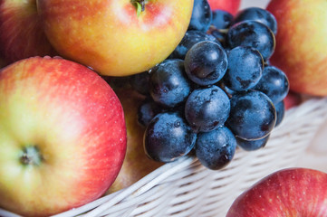 Blue grapes and apples, sweet natural fruits, background