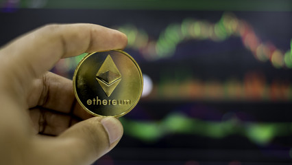 The gold ethereum coin with trading graph background
