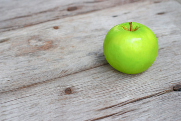 Green apple on wooden background 
