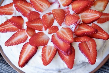 Delicious cake with fresh strawberries and cream  