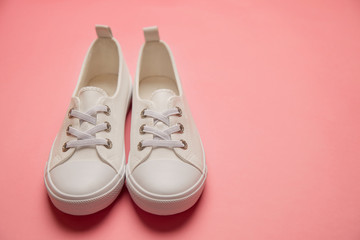 Overhead Shot Of White female Sneakers On Pastel Pink Background