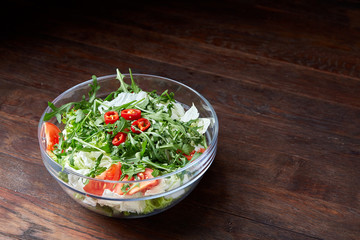 Dietary mixed salad in glass sultana on rustic wooden background, selective focus