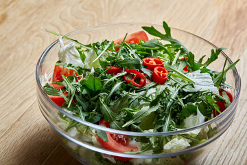 Dietary mixed salad in glass sultana on rustic wooden background, selective focus