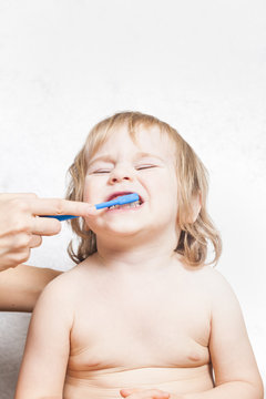 mother brushing  teeth baby