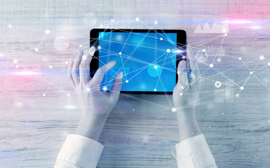 Hand using tablet with linking graphs charts  report and informational flow concept
