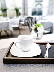 white cup of hot coffee on table