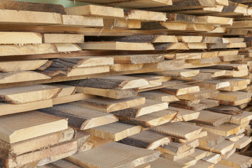 wooden beams stacked in a pile