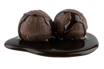 chocolate candy in liquid chocolate isolated on white background