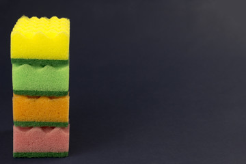 Fototapeta na wymiar .multicolored sponges for washing on a blue background