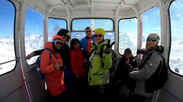 Group of tourists inside the gondola of cableway