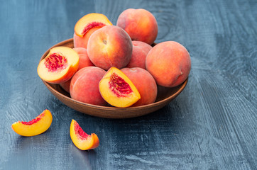 Fresh peaches on a wooden background. Close-up