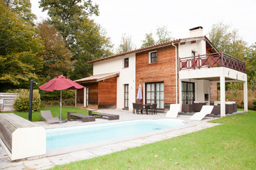 Fototapeta na wymiar Nice family house with large pool in garden
