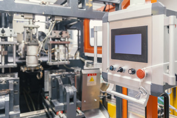 worker repairs a machine for plastic injection
