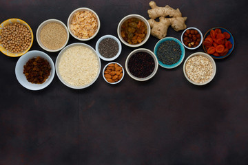 Top view different superfood, seeds and cereal on dark background with copy space. Flat lay set vegetarian healthy Clean food