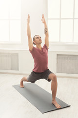 Man stretching hands and legs at gym