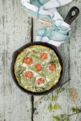 classic omelet with cherry tomatoes, cheese and herbs