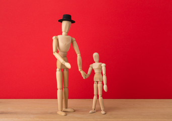 Wooden man mannequin with wooden child
