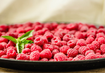 Fresh sweet raspberry and green basil.Selective focus. Horizontally..Detox diet food and raw vegan concept.