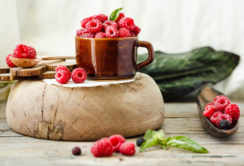 Fresh raspberry with basil in a cup of coffee and a wooden stand.Detox diet food and raw vegan concept.Horizontal.