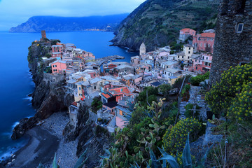 Aerial view of beautiful Vernazza in morning twilight ~ an amazing village perched on vertical cliffs by the rocky coast in Cinque Terre Italy