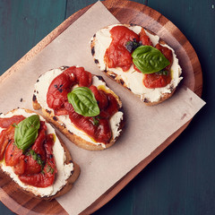 Snack set. Brushetta with cherry tomatoes, garlic, cream cheese and basil. Slow food, party food concept