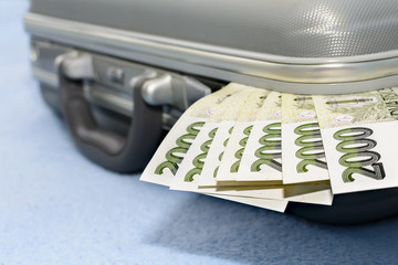 Czech money scratched in a gray metal suitcase. Many green banknotes in a briefcase. Money ready in...