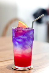 Glass of ice watermelon juice mixed soda and Butterfly pea juice. beautiful red and purple juice color.