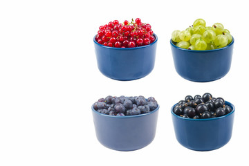 Berries on Isolated white background, bowl of Cherry, currant, blueberries, blackberries.