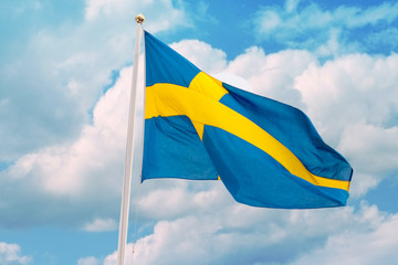 Sweden flag against a bright blue sky