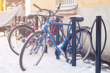 Fototapeta na wymiar Bicycles in a snow, illuminated by sun