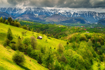 Wonderful spring landscape with snowy mountains near Brasov, Transylvania, Romania