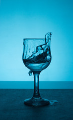 Splashes of water in a glass of wine