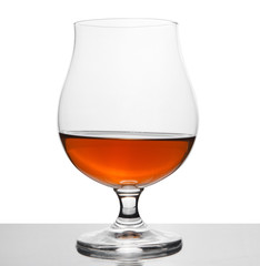 cognac in wineglass isolated on white
