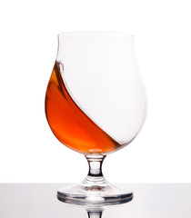 cognac in wineglass isolated on white