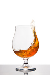 cognac in wineglass isolated on white