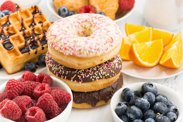 glazed donuts, sweets and fresh berries, closeup