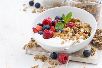 healthy breakfast with natural yogurt, muesli and berries