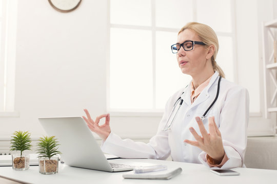 Serious Doctor Relaxing In Her Office