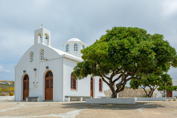 Traditional whitewashed Greek church located on Milos island, Cyclades, Greece. © vivoo