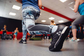 Team fitness training. Close-up of athletic shoes on training friends Bodys Fitness