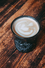 A glass of coffee on the table vertical photo