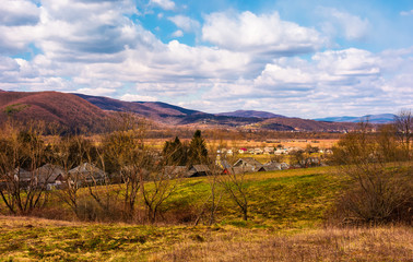 Fototapeta premium mountainous countryside in springtime. lovely rural scenery near the village on a cloudy day