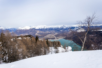 Fototapeta na wymiar Winter panorama of Alpago region and Santa Croce lake