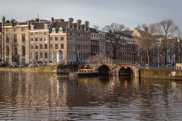 Papier Peint photo Canal water canals in Amsterdam with a bridge in the middle and traditional architecture